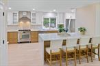 Stunning Fully Renovated Home in the Heart of Hampton Bays: where modern luxury meets everyday comfort. This beautifully renovated 4-bedroom, 3-bath home is thoughtfully designed for both relaxed living and stylish entertaining.At the heart of the home is a gourmet chefâ€™s kitchen, featuring top-of-the-line Bosch gas range, hood, quartz countertops, and an oversized 8&rsquo; x 5&rsquo; waterfall island with double-sided cabinetryâ€”perfect for prep, dining, and conversation. Additional premium appliances include a French door refrigerator with freezer drawer, microwave drawer, dishwasher, and an XO wine cabinet for your favorite beverages.The open-concept layout flows effortlessly from the kitchen into the spacious dining and living areas, creating the perfect setting for gatherings. Step down into the cozy den with an electric fireplace, custom built-in shelving, and cabinets that add warmth and elegance. A full bath on the main level adds convenience for guests.Upstairs, youâ€™ll find four generously sized bedrooms. The primary suite is a private retreat with a spa-like ensuite bath featuring a soaking tub, double vanity, and a walk-in closet. A second full bath with double vanity serves the additional bedrooms.Additional Highlights:LOW TAXES ! Central air. Dedicated laundry/mudroom with sink, cabinetry, and direct access to the 2-car garage.Beautiful hardwood and luxury vinyl flooring throughout.Fully finished basement with a stylish wet bar; ideal for entertaining or bonus living space.Expansive backyard with multilevel deck and partial white vinyl fencing; perfect for outdoor entertaining and play. New roof!Energy-efficient stainless steel appliances.Low-maintenance, move-in-ready living.Located just minutes from the beach, marinas, shops, and dining, this turnkey home offers the perfect blend of coastal charm and modern design.Donâ€™t miss your opportunity to own this exceptional property in Hampton Bays!