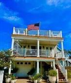 Location! Location! Location! UPPER BEAUTIFULLY FURNISHED WINTER RENTAL ONLY in a two family house one house from private beach, with spiral staircase to rooftop deck to see MAGNIFICENT sunsets and Atlantic Ocean. Ocean views galore! Beautiful, nautical furnishings. Hardwood floors throughout. The upper unit has an open floor plan with living room, dining area, EIK with doors leading to the front deck. Primary bedroom with full bath, bedroom, full bath, sleep loft, enclosed outdoor shower with hot & cold water. Seconds to private beach! Split unit in the living room, wall units in the bedrooms for a/c. Washer/dryer. Pet friendly with Landlords approval. One parking space included. Additional information: Appearance: Mint++