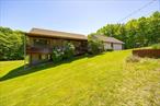 First time on the market in a generation, this Turkey Hill Charmer has it all. When you pull in, a lovely rocking chair covered porch welcomes you; begging you to spend your summer evenings listening to the birds and enjoying the upstate air here. Walk in to a formal entry way to an open living room with 20 foot ceilings, primary bedroom with en-suite bath off living room and 2 great sized guest bedrooms. Renovated bathroom with walk in shower and laundry hidden in the closet on this floor, for convenience and style. Open kitchen with high ceilings and breakfast bar island for snacking while the chef in your life cooks, or doing homework together. Dining area off kitchen lends to a nice open floor plan on this level. Off the kitchen is a mudroom/office/tv room that opens into massive 2 car garage with plenty of storage. Downstairs there is a large bedroom, living area, and full bathroom with handsome knotty pine. New pellet stove for efficient and cozy heating. Mechanicals are all in great condition and have been impeccably maintained. Glass sliders lead out to the side yard, could easily act as an in-law apt or guest suite. Off the mudroom walk out onto the large deck, huge inground pool with plenty of space to lounge and enjoy the sunshine all summer long. Beyond the pool we have over an acre of park like grounds with large shed for outdoor storage. Home is tucked back from the road under a canopy of trees that feels hidden but filled with sunshine and space for gardens, play or even some farm animal friends. The world is yours at Turkey Hill. 10 minutes to the TSP. 10 min to a Red Hook and 15 to Rhinebeck or Hudson, this a fabulous location to enjoy your Hudson Valley dream life.