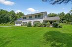 This 4-bedroom, 2.5-bath Colonial is nestled on over 5 peaceful acres along a private country road in the sought-after Washingtonville Central School Districtâ€”offering the perfect blend of seclusion and convenience. You&rsquo;re just minutes from public transit, shopping, schools, and parks. A long driveway leads to a charming paver walkway framed by mature landscaping. Inside, the classic center-hall layout welcomes you with a formal dining room on one side and a bright, sun-filled living room on the other. The updated kitchen is the heart of the home, featuring a center island with counter seating, stainless steel appliances, abundant cabinetry, a large pantry, and an eat-in area that overlooks the serene backyard. From here you can access the spacious paver patio ideal for relaxing or entertaining. The expansive family room boasts vaulted ceilings with exposed wood beams and a woodstoveâ€”perfect for chilly evenings or creating warm ambiance. The first floor also includes a half bathroom, access to the oversized two-car garage, and a laundry/mechanical room. Upstairs, the expansive primary suite offers a private retreat with a large en-suite bathroom complete with a soaking tub, stand-up shower, and access to storage. Three additional well-sized bedrooms share a full hallway bath with a tiled tub/shower combo. The exterior features a flat, usable yard with a mix of open space and wooded privacyâ€”ideal for nature lovers, gatherings, or just enjoying peaceful outdoor living. Fruit trees add a special touch to this already exceptional property! Don&rsquo;t miss your chance to enjoy the best of both worlds...peaceful country living with modern convenience around the corner. Come explore all that New Windsor and Washingtonville have to offer!