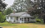 This Cottage is near the end of a dead-end street with 3+ acres of land has lots of potential. Build new or renovate and make it your very own. 3 Bay garages, one larger bay with a car lift. Inviting grounds give you the peaceful, serene grounds you&rsquo;ve always wished for. Great for Mechanics and Car lovers alike. Active garden area. 5 Sheds. Close proximity to stores and major roads.  Kitchen cabinets are wood. Great location. Property is being Sold as is. Recently sub-divided. Taxes at the 10, 890 were for all three properties. Taxes will be assessed next year.