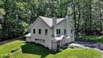 Wow! Country setting with all the room you need.1.8 acres with fenced back yard and surrounded by trees. This raised ranch is in the Minisink Valley School District and close to commuter routes and transport. It comes with an attached oversized 2 car garage(26&rsquo;X30&rsquo;), and a two car turn around off the driveway entrance. A recent addition offers a first-floor flex space; family room/office with a wood burning stove, a 1/2 bath, a large jacuzzi room and lots of storage. The whole house has a custom wide plank flooring. The main level offers a walk-out deck into the back yard. The large living room has a high efficiency fireplace. The primary bedroom comes with ensuite bathroom, a walk-in shower, double sinks, and walk- in closet. The second bedroom also has a walk-in closet. The third bedroom is equipped with a murphy bed to give you more options. The fourth bedroom includes an ample closet, four windows and has been used as a library/ music room. An additional hall full bathroom is also on this level. The kitchen has plenty of cabinet space and stainless-steel appliances, and a skylight. The dining room has large windows. The laundry room is also on this level. The property has its own septic, and well with an Aquasana Water Filtration system included. This is a must see property! It is rare to find a home with such private atmosphere in this area.