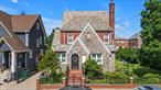 Welcome to This Stunning Tudor-Style Two-Family Gem Located in The Heart of Pelham Parkway nestled on an Expansive 50 x 100 Lot on a quiet, Tree-Lined Street. This Rare Find Blends Classic Architectural Charm with Spacious, Versatile Living Options-Perfect for Homeowners and investors alike. This Oversized Home features 2 beautifully maintained apartments a Spacious 3 bedroom Unit and a Comfortable 2 bedroom Unit, each offering Generous layouts filled with abundant Natural Light and Timeless character. Enjoy the Convenience of a Fully Finished Basement with Wine Cantina, Ideal for A Family Room, Recreational space or Home Office. Step into Your Private Lush and Palatial Backyard retreat with Mature Fruit Trees, Herb Gardens and serene landscape to Escape and truly Relax! In Addition, There is a Spacious Detached 2 Car Garage that Adds Tremendous Value & Convenience, with Plenty of Additional Driveway space for Parking or Storage! Just Minutes from Shopping and All Transporation! A Must See!