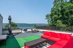 Begin each day with sweeping views of the Hudson River and the Palisades from your private rooftop deckâ€”ideal for savoring morning coffee or relaxing under the evening sky.This three-level townhome beautifully fuses natural serenity with modern comfort and convenience. Enter and you will find a tiled foyer that leads past a guest powder room into an immense great room featuring hardwood floors and a bay window. The galley kitchen with stainless-steel appliances and pantry completes this level.A sleek spiral staircase ascends to the second floor, where two generously sized bedrooms await, alongside a full hall bath. The oversized primary suite spans approximately 224?sq?ft, includes two closets and a private half bath. A practical hallway laundry closet with stackable washer and dryer adds daily ease.On the third floor, youâ€™ll find a spacious landing with a deep closet and direct access to your rooftop deckâ€”perfect for unwinding or entertaining while taking in million-dollar panoramas of the river.And hereâ€™s what makes this location even more compelling: youâ€™re just a short distance from the Greystone Metro-North station (approximately 5?minutes) on the Hudson Line, offering direct service to Grand Central Terminal in Midtown Manhattan in about 35â€“40 minutes. That means effortless commuting into the city while enjoying a tranquil riverside retreat.The property includes a private garage, an additional storage room, and exclusive resident access to the Lenoir Preserve for peaceful nature walks.