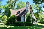 Everyone has been waiting for this house. First time on the market, ever, ever, ever! Noted Newburgh and Florida Architect Francis Abreu designed and built this Tudor side-split in 1922 for the Boynton family, the clan that shortly after Francis&rsquo;s brother Henry Abreu would marry into. Bespoke in every way, the house has all the original lighting, fittings, fixtures, and hardware. It is a genuine time capsule. All the windows appear to be Hope Jamestown casements with brass fittings which are just extraordinary. There are fun details at every turn and the side-to-side split is just ... delightful. We are looking for that one buyer that has the sensitivity to return this house to its former elegance.  Some restorations are not worth doing because the quality is not there. This house is an exception. The original build was first rate and the work has not been altered even after passing through three generations of the same family. Even better, it has a marquee Balmville location near the Powelton Club with mature landscaping and is in the very desirable Newburgh School District. The house has enormous curb appeal.From the front door a lovely vestibule opens to a high ceiling Living Room with one of those locally famous Abreu fireplaces that draws exceptionally well. The fireplace with builtin cupboards and adjacent bank of windows are the definition of charming. A broad archway to the dining room is flanked by corner cupboards and there is an original dinner bell on the arch exactly where it was placed in 1922.  The space opens to a screened-in-porch where entertaining may continue. The kitchen is small but exceptionally bright and presently has some nice Hosier cupboards. The rear Kitchen Porch spills down to the drive and a former chicken coop. Go figure. Also thru the kitchen is the stairway down to the former 2-car Garage, Boiler Room, Laundry Room, and a swinging 1970&rsquo;s Club Room.Back at the entry there are six steps up that bring you to a half level with an Office, Bedroom, and Full Bath, the landing of which overlooks the living room. That&rsquo;s part of the delight of this house. That half level goes up another half level to the top floor where you&rsquo;ll find the two largest bedrooms and another full bath with 9-foot ceilings. It&rsquo;s unusual for a English Tudor Cottage to be this bright and airy but the high ceilings and generous windows make it so. You would think on a half acre it would be more exposed but the landscaping gives it estate-like privacy that compliments this Balmville Road gem. Roman Architect Vitruvious once said that all great architecture must possess &rsquo;firmness, commodity, and delight&rsquo;; sixty-four Balmville Road embraces that maxim completely.