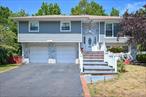 Sun-drenched, oversized Hi-Ranch in Woodmereâ€”ideal for extended family or true motherâ€“daughter living. Completely renovated from top to bottom, this home offers a modern, move-in ready interior with a versatile layout.Upper level: 3 spacious bedrooms, 2 full baths (including a luxurious primary suite), a formal dining room, and an updated eat-in kitchen with high-end cabinetry, granite countertops, and stainless steel appliances. Open-concept living area with hardwood floors, and abundant natural light.Lower level: 2 bedrooms, 1 full bath, bright living room, and a second kitchen with direct access to the backyardâ€”perfect for guests or multi-generational living.Enjoy outdoor entertaining on the raised deck overlooking a landscaped, fenced backyard with a green, tree-lined backdrop for privacy. Additional features include mini split units, renovated baths with lux finishes, walk-in closet, and ample storage.Located in Hewlett-Woodmere School District, close to LIRR, buses, shopping, parks, and schools. A rare combination of space, style, and location.