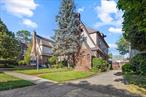 This ultra-handsome, true brick and fieldstone Tudor is surrounded by lovely, lush trees, featuring a charming front entrance. Step into a living room spanning the entire width of the home, featuring a wood-burning fireplace, plus an enclosed screened sunporch. Move through a large formal dining room where beautiful woodwork abounds, with two ways to enter the eat-in kitchen overlooking your spacious backyard. Four well-appointed bedrooms and 3 full bathrooms are thoughtfully arranged, plus a finished walk-up attic bonus room perfect for guests, a home office, or recreation. The finished basement boasts high ceilings and offers tremendous flexibility for entertaining or additional living space. Your private 50x100 lot provides mature landscaping and garden areas, complemented by a detached 2-car garage with convenient driveway parking. This impressive 2, 492 square feet of living space showcases classic craftsmanship with endless potential for your personal touch and updates. Located in desirable North Flushing, you&rsquo;re just blocks from Bowne Park&rsquo;s scenic pond, with easy access to multiple bus lines (Q15A, Q15, Q28, Q13, Q26) that connect to Manhattan and beyond. This exceptional property combines timeless elegance with tremendous space in one of Queens&rsquo; most established neighborhoods - a true rare find!