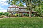 Discover your private beach retreat in this exceptional waterfront home perfectly positioned with shore-to-shore access between the Long Island Sound and Northport Bay. With breathtaking panoramic views and water access from both the front and back of the property, this rare gem offers the ultimate coastal lifestyle. Enjoy your private sandy beach on the Long Island Sound, as well as your bay-front access with existing dock in the backyard at Northport Bay. Step inside to a spacious living room featuring a cozy wood-burning fireplace, seamlessly flowing into an expansive family room. This inviting space is highlighted by oversized windows, built-in seating, and elegant French doors that invite the outdoors in. The updated kitchen is both functional and stylish, offering a peninsula, generous storage, and direct access to a large informal dining room. Enjoy family meals in the spacious glass-enclosed sunroom, which is heated for year-round enjoyment. From here, glass doors open to a multi-level deck, ideal for entertaining. Upstairs, youâ€™ll find four generously sized bedrooms, each with ample closet space (the fourth bedroom has been converted to laundry room/office.)The primary bedroom is a serene sanctuary, boasting two walls of sliding glass doors that lead to a private balcony overlooking the Long Island Sound, and sweeping views of Northport Bay. A wall of closets provides abundant storage. The home includes two beautifully updated full bathrooms, a half-bath on the first floor is ideal for guests, and a versatile laundry room/home office features built-in storage. Throughout the home, youâ€™ll find exquisite custom woodwork on every ceiling, adding warmth and character to this truly one-of-a-kind property. This home offers unparalleled access to the water, stunning views, and timeless craftsmanship in a premier Northport location. Donâ€™t miss this rare opportunity to own this unusual waterfront two-lot oasis on both the Long Island Sound & Northport Bay.