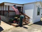 Discover the charm in this 2 Bedroom home. This home was manufactured in 2002. Inside you will find a large living room, Eat-in-Kitchen, full bathroom with sauna tub and shower. Outside you have a generous sized enclosed porch and a backyard to entertain also. Above ground oil tank and 2 sheds for storage. Land lease of $842.98 a month, which includes Taxes, water, snow removal, garbage and complex maintenance why rent when you can own!