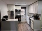 This beautifully updated two-bedroom unit features a spacious living room and a separate dining area. The open-concept kitchen is equipped with stainless steel appliances, including a stove, microwave, refrigerator, and dishwasher, complemented by quartz countertops and a matching backsplash. The unit also includes a modern, well-designed bathroom and hardwood floors throughout.The building is well-maintained with an elevator and a laundry room on the main floor. For enhanced security, there are cameras both inside and outside the building, along with key fob access and a live-in superintendent. Indoor parking is available, though a waitlist may apply. The location offers convenient access to shops, Fordham University, and the Botanical Garden.