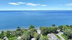 Million-Dollar Waterfront View with a Primary House and Cottage - An Opportunity of a Lifetime! Enjoy Sunsets From the Front Patio by the Fire Pit as the Water Shimmers and Waves Crash. Step Into the Main House and Find: 4 Bedrooms, 2 Full Bathrooms, and a Living Room Overlooking Captivating Views of Long Island Sound While Cozying Up by the Propane Fireplace. Oversized Primary Bedroom Offers Sound Views. Well-Sized Kitchen With a Screened-In Porch, Perfect for Entertaining and Outdoor Dining. Full Basement With Bilco Door Offers Ample Storage Space. Separate Cottage Is Great for Guests or Rental Income â€” Including 2 Bedrooms, 1 Full Bath, a Spacious Living Room With Water Views, Kitchen, and Dining Area. Make Memories That Last a Lifetime With a Nice-Sized Yard â€” Perfect for Gatherings, BBQs, Outdoor Games, a Swing Set, and More. Access to Private North Shore Beaches (With Membership), Plus Amenities Like Kayak Storage, Clubhouse, Renovated Bath Houses, and Community Events. Updated Bulkhead Below, Adding Peace of Mind. This Property Is Perfect as a Primary Residence With Income, Vacation Home, or Investment Opportunity.