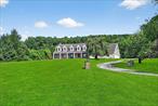 Stunning! Welcome to this totally renovated bright, beautiful and spacious colonial just 7 minutes from the Village of Warwick. Perched on 4.2 rolling and private acres with a lovely back yard perfect for an inground pool! Enjoy 4, 787 SF of luxurious living featuring 4 bedrooms plus an office and an entire guest suite with it&rsquo;s own entrance! These owners spared no expense with the high-end renovation of the kitchen and bathrooms. The kitchen has been totally gutted , featuring beautiful cabinetry and a Viking appliance suite with quartz countertops, a vented hood, wine cooler, two sinks and an oversized island with an LED-lit faucet! The primary bedroom suite is extraordinary with a large walk-in custom closet and a brand new bathroom with large soaking tub and an oversized marble shower with body jets, steam and a rain shower. The guest suite/studio features a kitchenette with a sink. Enjoy a four season sun room with a pool table included and a new split unit. The original heating system is intact and working as a backup system to the new heat pump system. The floors are brand new throughout. So much more to discover! Don&rsquo;t miss this one. Won&rsquo;t last!