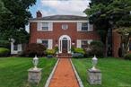 Welcome to this solid brick colonial that is situated on Malverne&rsquo;s prestigious professional row of homes. This home is conveniently located to the charming Village retail shops, personal care boutiques, service businesses, various food establishments, quaint parks and public transportation, to name a few. This home has all you could ask for! It features an inviting sunny entrance foyer, a sunken living room with woodburning fireplace and custom arched book shelves, a formal dining room and spacious eat in kitchen with granite counters and large island. The first floor also boasts a primary ensuite with a large full bathroom and two walk in closets! In addition, there is a first floor wing with two additional rooms that can function as two home offices or library, a study or a child&rsquo;s playroom. The space can also serve as a professional office, especially that there is a separate exterior entrance - perfect for a doctor, attorney, accountant, etc.. The second level offers three spacious bedrooms (one could actually be another primary bedroom) plus a full bathroom.               It gets even better! You can relax and enjoy the second floor fenced terrace overlooking the beautiful and manicured private rear yard.This home also has a massive attic for storage, plus there is an additional storage attic above the two car garage. Last but not least is the immaculate basement with four large windows that offer a good amount of daylight and plenty of room for a regulation size pool table and other family activities and gatherings.Other special items include all new interior doors, crown molding, custom radiator covers, custom hardware, slate roof on the main house and new architectural roof on wing. This is truly a one of a kind must see home in the beautiful Village of Malverne.