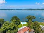 Welcome to an extraordinary opportunity to own a magnificent waterfront estate located in the heart of Kings Point, one of Long Islandâ€™s most coveted communities. Set on 1.5 lush, private acres with sweeping views of the Manhasset Bay/Long Island Sound, this contemporary residence offers the ultimate in luxury, comfort, and resort-style living. This expansive home features 6 bedrooms and 5.5 bathrooms across multiple levels, seamlessly blending refined architectural design with modern conveniences. The entry foyer welcomes you into a sun-drenched interior walls of glass, where nearly every room enjoys panoramic water views. The formal living room and dining room are ideal for grand entertaining, while the adjoining den provide warm, inviting spaces for relaxation. The chefâ€™s kitchen is outfitted with custom cabinetry, a center island, and breakfast areaâ€”all designed to maximize both beauty and functionality. The main level is anchored by two oversized primary suites, featuring dual spa-like bathrooms, generous custom closets, and a private sitting area. Upstairs, you&rsquo;ll find four spacious secondary bedrooms, three full bathrooms, and multiple terraces offering tranquil views and outdoor lounging space. The walkout lower level is an entertainerâ€™s dreamâ€”complete with a sauna, full bathroom, dressing area, and vast open space ideal for a gym, game room, media lounge, or wine cellar. Step outside to your own private oasis: a heated in-ground pool surrounded by lush landscaping, a fully equipped tennis court, and a private dock with deep-water accessâ€”perfect for boating enthusiasts. A 4 car garage and a private guest apartment with 2 bedrooms, bath and kitchen complete this magnificent home.