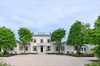 A singular and exceedingly rare residence, this exquisite home was masterfully designed by renowned AD100 architect Gil Schafer, featuring interiors by Antony Todd and landscape architecture by Warren Byrd, all set against panoramic views of the Hudson Valley and Catskill Mountains. This home is a Greek Revival masterpiece that blends timeless elegance with modern sophistication. As featured in Elle Decor, the interiors showcase meticulous craftsmanship and richly layered detail. A dramatic double-height entry gallery centers around a sculptural spiral staircase, offering a striking introduction to the home. From there, a 36&rsquo; x 24&rsquo; Great Room unfolds with 11&rsquo;+ ceilings, two wood-burning fireplaces, and French doors leading to an expansive covered porch that captures stunning sunset views. The kitchen is outfitted with top-of-the-line appliances, hand-hewn beams, dual pantries, and an inviting lounge area, perfect for gathering and entertaining. A large-scale wet bar connects the kitchen and great room, while the adjacent dining area opens to a beautifully landscaped pool terrace. A heated breezeway leads to private guest quarters, offering two en-suite bedrooms and a comfortable sitting room. In the west wing, a richly paneled library with fireplace sits beside the serene primary suite, which features hand-painted de Gournay wallpaper, dual dressing rooms, luxurious bathrooms, and views of an English garden and the rolling landscape beyond. Upstairs, two additional bedroom suites each feature private sitting areas and discreet breakfast bars, creating refined and restful retreats. An extraordinary offering where architectural pedigree, design excellence, and natural beauty converge.
