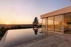 Modern Mountain Retreat with Vineyard, Infinity Pool & Breathtaking Views. Perched high on a mountain ridge overlooking the protected Bashakill Nature Preserve, this exceptional property offers a rare blend of sustainable living, cutting-edge design, and breathtaking natural beauty. Set on 41+ private acres, the sleek, energy-efficient residence features 2 bedrooms, an office, 2 luxurious full bathrooms, and an open-concept layout that seamlessly integrates indoor and outdoor living. Walls of glass frame panoramic views, while the infinity pool appears to spill into the preserve below. A sleek and sexy kitchen is fully equipped for entertaining with sub zero fridge, large waterfall granite island with built in wine fridge and access to the pool cabana. Motorized sun shades and hidden TV transform the sunlit living room into a cozy media room. The home was designed smart with low maintenance materials, solar energy, radiant heating and all can be controlled remotely from your phone or tablet. A pneumatic vacuum elevator provides easy access to all levels, and the oversized 3-car garage with tesla charger offers ample space for vehicles and storage. The estate includes a producing vineyard, a barn outfitted with a commercial kitchenâ€”ideal for agricultural venturesâ€”and a charming blueberry cabin nestled atop the rocky ridge. Two additional homesites on the property provide exciting potential for expansion, guest homes, or future investment. Whether you&rsquo;re seeking a serene escape, an eco-conscious lifestyle, or a unique hospitality opportunity, this modern mountain sanctuary delivers it allâ€”with style, sustainability, and unforgettable views. The property is being offered move-in ready, fully furnished and with landscaping/farming equipment.