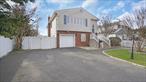 Enjoy privacy and tranquility in this beautiful and updated Hi-Ranch featuring 5-bedroom, 3-bathroom with a decent sized fully fenced backyard, perfectly situated on a quiet cul-de-sac. Experience the best of both worldsâ€”seclusion with minimal traffic, yet just minutes from LIRR, major highways, Belmont State Park and local conveniences.Perfect for extended families, income potential (with proper permits), or work from home office, this unique property offers three separate living spaces, each with separate entrances, featuring bedrooms, bathrooms, and kitchens.The second floor boasts an inviting open-concept design, featuring a kitchen, a formal dining room, a spacious living room with hardwood floors, a full bathroom with and three generously sized bedrooms.The first floor has two separate living spaces featuring 2 bed, 1 bath with kitchen and garage converted into den with full bath and summer kitchen. House has New roof and HVAC (only 2 years old). Other amenities include in-ground sprinklers and public sewer. Do not miss this unique opportunity. Come take a look and make this your own.