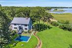 Stunning Waterfront Retreat w/ Modern Luxury on 4+ Private Acres. Experience serene luxury in this completely renovated home offering year-round views of Goose Creek and 250 feet of direct waterfront. Nestled on nearly 4.5 acres of pristine landscape, this private oasis is located in a highly desirable community with amenities including beach access, kayak storage, and docking. Designed for both relaxation and entertaining, the home features an open-concept layout with seamless indoor-outdoor flow. The gourmet kitchen is a chef&rsquo;s dream, equipped with twin Bosch refrigerators, a Bosch dishwasher, ice maker, warming oven, and a Bertazzoni 6-burner stove/grill. Custom mission-style cabinets by Legacy and elegant white quartz countertops elevate the space. The bathrooms have been tastefully updated with designer finishes, while the interior boasts clean lines and sophisticated design throughout. Step outside to enjoy your brand-new heated saltwater pool, surrounded by bluestone pathways and lush, professionally designed landscaping. Over 170 mature Green Giants, holly hedges, and crape myrtles provide both beauty and privacy. Water fountains placed throughout the grounds offer a tranquil, Zen-like atmosphere. Additional features include new decking with water views, enclosed outdoor shower with copper shower system and new fencing for added privacy. This is more than a home-it&rsquo;s a lifestyle sanctuary, combining natural beauty, modern comfort, and high-end design in a breathtaking waterfront setting. Enjoy benefits of living on the water without being in a flood zone!