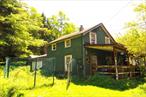Embrace the charm of a bygone era with this turn-of-the-century American Farmhouse style home, a spacious 3-bedroom, 1-bathroom house brimming with potential. Step onto the welcoming, large covered front porch, perfect for enjoying the breeze and unwinding. Inside, the generous living room features a cozy wood stove, promising warmth and ambiance during cooler months. The eat in kitchen is also quite spacious and welcoming.While some deferred maintenance provides a chance to update and personalize, this property offers incredible upside. Imagine restoring the historic details to their former glory or infusing the space with your own contemporary flair. Outside, the potential for additional income or guest accommodations is evident with two RVs (one large, one small) already on the property, providing options for rentals or hosting family and friends.Beyond the home, discover a small pond fed by a natural spring. With some care and cleaning, this picturesque water feature could become a pristine oasis, attracting local wildlife and creating a tranquil retreat. The environmental benefits of a spring-fed pond are numerous, including natural water quality and a consistent water supply.This is more than a house; it&rsquo;s an opportunity to create a dream home in a desirable setting. Don&rsquo;t miss the chance to invest in this property and unlock its full potential. The land is where the real value is. Finding a property with a year round spring is not easy. Here is your chance to own one at an affordable price