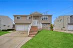 This magnificent and updated wide-line Hi-Ranch is perfectly situated in the desirable community of Massapequa. The upper level boasts a spacious living room that is bathed in natural sunlight and offers a warm and inviting atmosphere. The dining room leads to a lovely balcony, ideal for enjoying your morning coffee or sunsets. The new eat-in kitchen is equipped with stainless steel appliances and abundant counter space. The master bedroom hosts a stunning en-suite bathroom, along with two additional well-appointed bedrooms. Lower level: On the first floor, you&rsquo;ll find an additional bedroom and an updated bathroom, providing versatility and privacy. Step outside to discover your private oasis; This tranquil space is beautifully landscaped and offers plenty of room for outside activities. The home is filled with modern amenities, including recessed lighting, beautiful chandeliers, and hardwood floors throughout. Also included is a new energy-efficient gas boiler, a two-car garage, and a driveway with ample parking for guests. Located near schools, LIRR for easy commuting, a variety of restaurants, and local parks, this home offers the ideal combination of comfort and convenience. Don&rsquo;t miss the opportunity to make this incredible home yours!