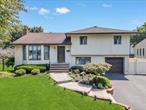 Welcome to this beautifully maintained split-level home, set on a professionally landscaped lot in a highly sought-after neighborhood. This sun-filled residence offers multiple inviting living spaces, including a bright living room with gleaming hardwood floors and an open-concept layout that seamlessly connects to the formal dining areaâ€”perfect for entertaining. The heart of the home is the updated eat-in kitchen, featuring vaulted ceilings, skylights, and abundant cabinetry that blend style with practicality. A cozy den with exposed beams and a private outside entrance adds both charm and flexibility, making it ideal for guests, extended family, or a private home office. The spacious master bedroom offers a relaxing retreat, complemented by two full bathroomsâ€”one of which is fully renovated with modern finishes. Additional bedrooms are generously sized and filled with natural light. The newly finished basement provides bonus living space, perfect for a recreation room, gym, or media area. With its combination of space, style, and functionality, this move-in-ready gem is not to be missed!