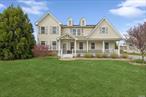 Discover the enchanting charm of this traditional two-story home in the heart of Eastport, a prime location known for its proximity to baybeaches and convenient access to New York City and the Hamptons. This turnkey residence is beautifully framed by a clear sunny front lawn and an inviting covered front porch with classic white columns, setting the tone for a warm welcome. Upon entering, you are greeted by a grand entry parlor boasting double-height ceilings and abundant natural light that enhances the beautiful hardwood floors throughout. The home features a well-defined layout including a dedicated dining room for formal meals and a cozy breakfast nook adjacent to a kitchen equipped with granite countertops and premium appliances. The inviting living room, complete with a fireplace and patio egress, ensures a perfect setting for both relaxation and entertainment. Offering four bedrooms and 2.5 baths, this home includes two ensuite bedrooms on the second level, providing ample privacy and comfort. The home office or den area provides a flexible space that can serve as your sunny retreat all year round or be converted into a convenient first-floor bedroom. The unfinished lower level presents a blank canvas awaiting your personal touch to create your dream space-be it a home theater, gym, or additional living quarters. Outside, the bright and sunny backyard is ideal for dining al fresco and enjoying peaceful moments in the open air. The residence is part of a private, gated community, which adds to the allure with resort-like amenities, including tennis courts, a swimming pool, a gym, and a clubhouse. With its serene location and outstanding community features, this home offers luxury and comfort and a lifestyle of ease and elegance, making it a perfect retreat or full-time residence. basic star discount if main residency 1097 rebate check from state