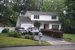 Charming Colonial in the Lake Hills section of Ronkonkoma. This 4 bedroom 1.5 bath home features both a formal living room and dining room, each with hardwood floors. Eat in kitchen features upgraded appliances with luxury vinyl plank floors. Large den is perfect for family gatherings with a half bath and sliding doors with access to a large trex deck. Upstairs features 4 bedrooms, all with hardwood flooring. Spacious main bedroom features a large walk-in closet. Additional features are central AC, Anderson windows. Newly remodeled bathroom and a new oil tank , driveway, and paver walkway and porch. Upgrades galore inside. Don&rsquo;t miss out on a great opportunity.