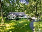 Tucked back on a private corner lot on one of Chappaquaâ€™s most desirable and quiet streets, this expanded mid-century ranch offers a rare opportunity to create your dream home in an award-winning school district. The property is well situated on the lot, leaving plenty of space for a pool or future outdoor expansion.Inside, the home offers a light-filled layout with generously sized rooms, walls of windows, and a natural flow between indoor and outdoor spaces. The kitchen opens to a large living and dining area anchored by a slate-surround fireplace and wide views of the level, park-like backyard. French doors lead to a deck and stone patioâ€”ideal for relaxing or entertaining.A spacious great room with wood-burning stove and powder room adds flexibility for everyday living. The main level also features an ensuite bedroom with glass doors to the yard, along with two additional bedrooms and a full hall bath. Upstairs, you&rsquo;ll find another bedroom, a full bath, a study, and a bonus roomâ€”offering a flexible layout that lives like a 5+ bedroom home.The current owners have already begun the process of restoring and upgrading the home, and itâ€™s ready for its next chapter. With potential for reconfiguration or expansion (with approvals), this is a smart value opportunity in a location where homes are rarely available at this price point.Just minutes from the train, town, schools, Whole Foods, and Lifetime Fitness, this peaceful and private retreat offers convenience without compromise.
