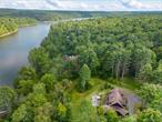 This custom Adirondack Lake Home is loftily placed on a majestic 5.38 acres with 393 feet of prime lake frontage on the Swinging Bridge Reservoir. The Lumberland phase of this community is known to have forever wild views as the restrictions on the opposite shoreline prohibit residents from building within 300&rsquo; of the reservoir. Construction on this lake side beauty was completed by the premier builder within The Chapin Estate. 3, 162 square feet of luxury rustic style living with full deck with covered area overlooking water. Creative outdoor living and play areas were thoughtfully designed that significantly increase the use of the natural outdoors. The home has 4 bedrooms, 4.5 baths, gourmet kitchen, a fireplace, 2 firepits, large sideyard/play area and gravel road leading down to the dock, shed and meticulously manicured lake frontage. Furniture, dock and newer pontoon boat are all included. All within a gated preserve featuring a member&rsquo;s only Lake Club. Located at the Chapin Estate, a 4-season gated residential preserve tucked discretely amidst 2500+/- acres of pristine forest lands and bordering 14, 000 acres of protected conservation lands. Unique attributes include: 2000 acres of freshwater reservoirs and trout streams; 9+ miles of hiking, biking and riding trails. Minutes from Bethel Woods Performing Arts Center. 2 hours from NYC, even less from North Jersey. Minutes from Bethel Woods Performing Arts Center. 2 hours from NYC and even less from North Jersey. 15 minutes from Monticello Motor Club, Resorts World Catskills, Kartrite Water Park and Yo1 Wellness Center. Boutique Hotel with restaurant, bar and spa to be available to residents. (*Short term rentals are not permitted. Rental minimum of 3 months no more than twice per year.)
