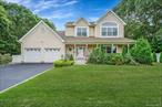 Embrace nature and privacy at 4 Dixon Street, Yaphank. Minutes from Sunrise Highway and 495, this paradise property rests aside woods at the end of a quiet cul-de-sac in the Chelsea Victoria Community, where there is only one way in and out of the development for added privacy and security. This colonial victorian is a beautifully updated,  4 bed 2.5 bath colonial has so much to offer. Vaulted ceilings and open floor plans meet all of your of entertaining needs, inside and out.  A quiet, backyard with deck and gazebo and no noise from traffic! MAIN LEVEL open floor plan... formal dinning room, living room , den 1/2 bath & tons of natural light in kitchen. On the SECOND FLOOR find all bedrooms, 2 full baths including primary w/ ensuite and walk in closet. Full basement with outside entrance perfect for possible mother-daughter with proper permits. Two car garage, Solar Panels (financed with roughly $12, 000 remaining, they are not leased) in-ground sprinklers and so much more, an absolute must see!