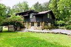 Located in the vibrant town of Warwick NY you will find this renovated gem situated on 1 acre of park like property surrounded by mature trees. This home has been restored to mid century modern design and elegance. Your guests will feel at home with the convenience of a first floor bedroom and private bathroom. The windows with natural light make this space warm and welcoming. Entertaining is effortless in the spacious kitchen with NYC themed concrete countertops, five star appliances and an open floor plan you will love! Yes, there is enough room to grow and host a number of guests with 4 generously sized bedrooms all with hardwood flooring and ample closet space. Beautifully designed bathrooms (3.5 in total) all with well appointed finishes. The main living room area is the focal point featuring soaring ceilings, fireplace and powder room. Other special features include sauna, primary bedroom with fireplace and flex space for ping pong or pool table. A unique cottage wing completes this home and can be used for a sound studio, private guest suite, home office or Airbnb. Property is surrounded by fencing and includes a two car garage with work shop. A little bit about the area - located just 8 minutes from the downtown Village of Warwick where you will find restaurants, cafes, boutiques and other specialty shops. Surrounded by wineries and orchards that are open year round. The Hudson Valley is also known for Woodbury Common outlets just 30 minutes away! Make an appointment to see this very special home - itâ€™s waiting just for you!