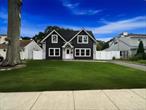 Expanded and renovated in 2019, this stunning 4-bedroom, 3-bathroom Colonial offers a unique blend of modern updates and timeless design. The exterior showcases eye-catching vinyl siding with stone accents, a welcoming roofed front entry, and an expanded driveway that leads to a detached garage at the rear of the property. Inside, the open floor plan features a bright white kitchen with granite countertops, stainless steel appliances, and a center island perfect for entertaining. The spacious living room flows into the formal dining room with sliding glass doors that open to the backyard. A cozy den, first-floor bedroom, and full bath complete the main level. Upstairs, the oversized primary suite boasts a full bathroom and a walk-in closet, along with two additional bedrooms and another full bath. Beautiful hardwood floors and recessed lighting run throughout the home. Enjoy year-round comfort with central air conditioning and gas heating. The large yard is ideal for gatherings, featuring a paver patio perfect for outdoor living.