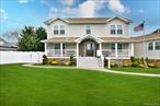 Move-In Ready Waterfront Gem Beautifully Rebuilt & Raised In 2018. This Elegant Colonial Is Located In The Nassau Shores Section Of Massapequa Near Shopping, Restaurants, Nightlife, Golf, Marine Activities & Transportation. This Home Features Dark Engineered Hardwood Floors Throughout, Recessed Lighting, Cac For Cooling & Heating, Smart Home, Ring Doorbell, In-Ground B-Hyve Sprinkler System, Every Room is Hardwired For Fiber Optics, Phone, Speaker, HDMI & Plenty Of Room For Everyone With 5 Bedrooms , 3 Full Bathrooms & 1 Car Garage. Impeccable Curb Appeal As You Approach This Home With Trex Porch, Stone Facade & Paver Walkways. The Open Kitchen Features White Custom Cabinetry, High End Bosch SS Appliances, Double Wall Ovens, Glass Subway Tile Backsplash, Quartz Countertop & Contrasting Center Island, Formal Dining Room W/Glass Door Leading To Backyard, Living Room W/Recessed Lighting & Sleek Electric Fireplace, Two Bedrooms & One Full Hall Bathroom Are On The Main Level. The Second Floor Offers A Primary En-Suite W/ Full Bathroom Including Double Vanity & Shower, WIC & Private Terrace For Watching Those Beautiful Sunsets Or Sipping Your Morning Coffee Plus Two Additional Bedrooms And A Full Hall Bathroom As Well As A Handy, Convenient Laundry Area. Fully Fenced-In Private Backyard Oasis With HotTub, Outdoor Bar Which Sits Up To 10, Including A Gas Bbq & Navy Bulkhead To Park Your Boat Or Jetskis. Attic With Pull Down Stairs With Plenty Of Storage.... Possible Mother Daughter With Proper Permits . Nothing To Do In This House But Unpack And Enjoy The Summer ! Welcome HomePre-Approval Or Pof Required By All.