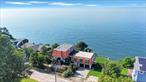 Welcome to this truly unique 3 story waterfront home offering over 5, 000 sq ft of living space, located right on the Long Island Sound with direct access to the private West Beach. This 3 bedroom, 2 bath home features an open floor plan with stunning water views, perfect for entertaining, with a chefâ€™s kitchen equipped with high-end commercial-grade appliances. The main floor has been updated with beautiful new terra-cotta flooring, adding warmth and charm to the already inviting space. Custom doors and architectural details flow throughout the home, adding character and warmth. The entire top floor is dedicated to a massive primary suite complete with one of three fireplaces offered with this home, a spa like master bath, and sweeping water views. Outside, enjoy a newly installed upper retaining wall, fresh sod, and a 2-car garage. This is a rare opportunity to own a one of a kind waterfront property that offers luxury, space, and private beach access, all in one.