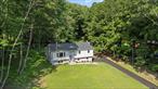 Amidst nature, surrounded by lakes, mountains, and the Appalachian Trail, this beautifully renovated raised ranch sits on a sprawling 1.7-acre lot, partially wooded for ultimate privacy. Featuring 3 bedrooms and 2 full baths, this home offers a bright, open living space with tall windows in the living space that flood the interior with natural light. The chefâ€™s kitchen is fully updated and perfect for entertaining. Enjoy a covered back porch overlooking a serene, private backyard bordered by woods. Flexible floor plan offers potential for a mother-daughter setup. Legitimate lake access. New roof, sidings, kitchen, bathrooms, floors, windows, doors, steps, deck, water tank, boiler, oil tank, walkway, driveway, 200Amp electric panel. Conveniently located near highways, the Southeast train station, Carmel town center, and everyday amenitiesâ€”while still providing scenic beauty and tranquility. A perfect blend of modern living and nature!