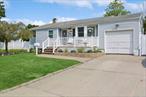 Unique remodeled spacious ranch. Large 3 bedroom Ranch layout on main floor. Lower level has an additional 2 bedrooms, bath and outside entrance.  Main level has beautiful light white kitchen remodeled 3 years ago. Center island with quartz counters and stainless steel appliances. Full bath remodeled apx. 6 years ago. Large living room area for entertaining. Step down den off kitchen with sliders to the patio area.  Lower level: 2 bedrooms, 1 bath, spacious living room and remodeled kitchen and laundry. New luxury viny flooring throughout. Complete outside kitchen with hot and cold running water, barbecue, refrigerator for summer entertaining. Also large shed with electric. New Central air conditioning on both levels with 2 year old mini splits on lower level. 200 amp electric service installed 7 years ago. New septic system installed. 5 zone In ground sprinklers. EV charger hook up as well. Too much to list!