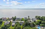 This lovely water view home in Glen Cove is in good, move-in ready condition. It offers over 2, 638 sq ft of living space on a large 20, 000+ sq ft lot. Located in a quiet Long Island North Shore neighborhood, the home has three levels with bright, open rooms and beautiful ocean and garden views. The first floor includes a spacious living area, full bathroom, gym, laundry room, and access to a two-car garage, plus front and back patios. The second floor has two bedrooms, two full bathrooms, a kitchen, living room, and formal dining room, with front and rear balconies that overlook the bay. The third floor is used as an office but can be turned into a bedroom. Outside, there&rsquo;s a wide circular driveway and a landscaped backyard, great for relaxing or entertaining. Residents have private access to East Island beach, and the area is close to parks, golf courses, shops, restaurants, and top private schools.