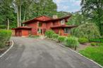 Stunning Mid-Century Modern Masterpiece â€“ Inspired by the iconic style of Frank Lloyd Wright, this home showcases timeless horizontal lines, an open floor plan, and seamless integration with the natural surroundings. Set on 1.84 acres of park-like property with a beautiful pond, this private retreat is located in the heart of New City with easy access to the Palisades Parkway. The dramatic sun-filled entry opens to 5 bedrooms and 4 baths, including an expansive primary suite with gas fireplace, spa-like bath with steam shower, and Jacuzzi tub. Walls of windows flood the chefâ€™s kitchen, breakfast area, and butlerâ€™s pantry with light, framing serene backyard views. Enjoy multiple fireplacesâ€”including one in the living room and a woodburning stove in the basementâ€”plus a finished walk-out lower level featuring a home gym, billiard room, bedroom, full bath, cedar closet, storage room and private patio. Outdoor living is elevated with a wraparound deck, circular driveway, whole-house generator, and 2-car garage. Come visit and thoroughly enjoy this absolutely gorgeous home!