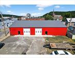 This building and property includes 4 lots (98, 104, 106, 110) totaling 23, 500 sq ft. The 7600sq ft building (6000 sq ft main and additional 1600 sq ft.) sits on 10, 000 sq ft lot (98), leaving 2400 sq ft parking near the rear entry of the 40x40 building. The building has a new metal roof with new insulation. Inside is freshly painted white. There is new poured concrete flooring throughout. Plumbing is roughed in for 2 bathrooms ADA compliant, inspected. There are 2 new automatic overhead doors 12&rsquo; 6 x 11&rsquo; 10, and 2 new manual overhead doors 8&rsquo; 10 x 9&rsquo; 10 (in 40x40building), also 2 new walk in glass doors. Electric is 3 phase 200 amp and can be updated to 600 amps. Building has a 23&rsquo; ceiling height at peak making a loft a possibility. This building is adaptable and can be reconditioned as needed. Outside there are 3 additional lots (104, 106, 110). These lots are 50x100, 50x100, and 50x70. They are included in the sale and make for ample parking. Town is open to a variety of zoning options. Reach out to the listing brokers for more information.
