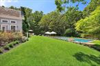 This traditional home has a gorgeous appeal both inside and out. From the top level landscaping to the picture perfect entry way, the property checks all the boxes. The first steps inside are welcoming and bright, with a large den/office space and open entry into the formal living room and professional kitchen. The top of the line kitchen is eat-in and flows out to a comfortable sitting room and patio space. The double height living space has a fireplace and is centrally laid out for entertaining. A large primary on the first floor; this four bedroom home also works as a five total bedroom home. Totaling 7, 000 sqft with the finished lower level; any large family can find space to work, play or have a quiet moment. The back yard only continues the eloquence of the property with a built in grill, overside 44x20 gunite pool and mature landscaping that blooms all summer. This home is one of a kind and price to sell.