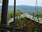 Secluded Scenic One-Bedroom Retreat- This comes with two lots making almost a complete acre.Nestled above a breathtaking panoramic view, this one-bedroom hideaway is perfect for those craving peace, nature, and serious scenery. Itâ€™s not for everyone â€” to get here, youâ€™ll need to climb over natural terrain with no formal path â€” but the reward is total privacy, endless sky, and a one-of-a-kind outlook youâ€™ll never forget. Whether you&rsquo;re an artist, a hiker, or just someone who wants a unique getaway, this is a rare find that you wonâ€™t find again.