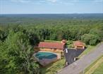 On a clear day - You can see forever! and ever! Million-dollar view, stately and solid home with fabulous grounds, amazing property and amenities is perfectly situated at the end of a dead-end road. With gorgeous vistas and over 15 acres of land accessed by two roads, this is a special offering in the Town of Neversink. Home has been lovingly maintained and used by the same family since it was built, was updated within the past 4 years and is move-in ready. With open plan looking out onto the glorious views, this one checks many boxes including sought after location, in-ground heated pool, detached garage and LOW taxes. Three bedrooms, ample closet space, primary suite with laundry and accessibility features make this a home that will deliver for years to come. The sun-lit lower level offers recreation and game room, complete with vintage pool table, pellet stove, full bath and additional room for office or study. The deck is perfect for star gazing, entertaining, and barbeques and the gazebo is such a romantic and restful place to ponderâ€¦