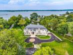Experience unparalleled luxury and craftsmanship in this spectacular new construction nestled on over an acre of pristine waterfront property in the heart of Kings Point. This one-of-a-kind custom-built estate spans approximately +/- 8, 000 square feet of sophisticated living space, artfully designed for both grand entertaining and serene everyday living. From the moment you arrive, the home impresses with its timeless architectural design, extensive millwork, and impeccable finishes. Soaring ceilings and walls of glass flood the interior with natural light and frame breathtaking panoramic views of Manhasset Bay. Designed for effortless living, this stunning residence offers 6 spacious bedrooms and 5.5 designer bathrooms. The main floor boasts expansive formal living and dining rooms with direct water views, a large family room, Library and a state-of-the-art gourmet kitchen featuring top-of-the-line appliances, custom cabinetry, and a large center island perfect for entertaining. Wake up to peaceful water vistas in the luxurious primary suite, complete with a spa-like en-suite bath and generous closet space. Secondary bedrooms offer flexibility for family, guests, or office use, all thoughtfully laid out to maximize space and privacy. Set on a private lagoon with direct access to Manhasset Bay, this home is a kayakerâ€™s paradise and an outdoor enthusiastâ€™s dream. The beautifully landscaped grounds are an entertainerâ€™s haven, featuring an oversized deck, in-ground swimming pool, and lush green space ideal for hosting gatherings or relaxing in your own private sanctuary.