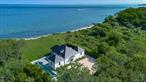 At the end of a secluded, private one-mile road, where the land meets the Long Island Sound, this newly renovated modern beach house offers breathtaking views, refined design, and total privacy. Set on two-thirds of an acre and surrounded by two 30 acre privately owned parcels of land, one of which is entirely vacant, the home features over 100 feet of private beachfront with a naturally sloped path leading to the shore. Every inch of this residence is bathed in natural light and designed to celebrate its stunning surroundingsâ€”from the expansive great room with white oak flooring and gas fireplace to the vaulted dining area and sleek kitchen with a gas stove and integrated workspace. The primary suite includes a spa-inspired bath with a sauna, shower, and bidet, while the additional first floor bedroom has an en-suite bathroom with a second floor bedroom as well. There is a full fitness center in a finished basement with heat and central air conditioning with walk out stairs to the pool area. All new Pella black-framed windows perfectly frame the Sound, with nearly every room offering unobstructed water views. Outside, lush landscaping and vibrant hydrangeas surround a 50â€™ x 8â€™ heated saltwater gunite pool with an automatic cover and stone patio, creating a peaceful outdoor retreat ideal for both entertaining and everyday living. The white board and batten siding, matte black metal roof, and detached one-car garage complete the clean, modern aesthetic. With porcelain tile sunroom floors, low taxes, and deeded road rights with private gate, this is a rare opportunity to own a fully renovated waterfront home with unrivaled serenity, where the sunsets, sea breeze, and silence feel like your own private oasis.