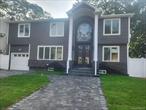 Totally and completely renovated! Stripped down to the studs. Magnificent 5 bedroom/ 5 Bath Colonial, in the middle of beautiful Massapequa Park Village. Enjoy the convenience of walking distance to many restaurants, cafes, shopping, and only a block away from the train station. Open concept featuring a modern kitchen with a 5-burner stove and an additional wall oven, microwave combo. Quartzite countertops. Waterfall over-sized island, with a wine fridge and extra storage. 1st floor is complete with radiant heated floors. All 5 marvelous bathrooms include smart toilets, mirrors, and radiant heated floors. Every bedroom has a customized closet organizer. Modern Frameless Glass Railings throughout. New roof, new siding with stacked stone accent. One car garage, paving stones 2 car driveway and walkway, leading you up to a majestic entrance with pillars and eight-foot-tall wrought iron double doors. 2-zone air conditioning system. Finished basement with egress window and laundry room. Sprinkler system. All fenced in. Plus...Massapequa School District #23. This house has it all! It is a MUST SEE!! More pictures to follow.