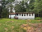 Diamond in the rough !  This manufactured home sits on a quiet country road on a level 3/4 acre lot. It has 2 bedrooms and one bath, living room and kitchen, space for laundry hook ups and a large wrap around enclosed porch. With a little TLC this could be a great first time home, retirement home or rental. Sits on a quiet country road in Barryville, NY. Close to the Delaware River, Area Lakes, Farmer&rsquo;s Markets, Bethel Woods. Less than 2 hrs from NYC. Sold As Is.
