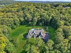 Tucked away on a secluded 5.5-acre property, 55 Enoch Crosby Road offers a private and peaceful setting. This quality custom-built 6, 882 sqft. Contemporary Colonial, complete with an Accessory Apartment, showcases a thoughtful and well-planned design. The lighted, tree-lined driveway leads to serene grounds accented by mature trees, rolling lawns, colorful gardens and blooming shrubs. The beautiful outdoors features a 16 x 38 ft. in-ground pool perfectly paired with an oversized pergola, retractable awnings, and large deckâ€”creating inviting spaces for relaxation, gardening, and seasonal entertainment. Inside, generous open living spaces are complemented by quality features such as radiant floor heating, ADA-accessible rooms, inlaid flooring, and recessed lighting. The 3, 766 sqft. main level offers a welcoming foyer, formal dining room, family room/den, sunken living room with gas fireplace and a wall of custom sliding doors & windows that allow natural sunlight to radiate. The spacious first-floor primary suite boasts his-and-her walk-in closets, floor-to-ceiling tiled shower, Jacuzzi tub, and direct access to your private outdoor retreat. The eat-in kitchen is appointed with granite countertops, gas range, pantry, wine fridge, and double wall ovenâ€” ideal for both entertaining and everyday cooking. Conveniently located on the main level, a half bath, laundry room with a built-in doggie bath provides ease for pet lovers. The second-floor recreation room provides the perfect space for family gatherings and entertaining, complete with room for a full-size pool table, inviting lounge areas, with a spacious family room just steps away. The open catwalk layout overlooks the main level and connects two generous-sized bedrooms, bonus room, large full bath, and convenient hall office space. The one-bedroom accessory apartment offers two private entrances, fenced-in yard, separate heated garage, and private deck. Inside, you will find a large dining room, den/study, kitchen with center island, double oven and granite countertops. The accessory apartment is ideal for extended family living, in-law or mother/daughter suite, rental income, airbnb, or professional home office/business. The large driveway and heated 4-car garages provide considerable space for parking and extra storage. The expansive walkout basement, complete with wood-burning stove with floor to ceiling custom stone wall and additional full bath, invites many possibilities. Thoughtfully designed, this home offers ample storage and closet space, including an easy-access full walk-up attic. Whether youâ€™re seeking multigenerational living or simply appreciate fine design paired with natural beauty, this exceptional residence offers the perfect blend. The Enoch Crosby area is located in a sought-after community near the Middle Branch Reservoir, golfing, bike paths, local restaurants, shopping & Danbury CT. GREAT commuter location with its close proximity to 3 Metro North Train Stations, Route 684/84, 27 miles to Westchester County Airport, 30 miles to White Plains, 59 miles to NYC .