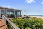 Spectacular Beachfront Home in Secluded Setting! Impeccably renovated from top to bottom, this beachfront home for sale in Water Island boasts panoramic Atlantic Ocean views, 3 bedrooms, 2 bathrooms, and a spacious wraparound deck. Located in Spatengaville, an exclusive enclave of Water Island with only 4 homes, this one of a kind home offers the utmost privacy, peace, and quiet in a truly spectacular setting. With lush vegetation and National Seashore Preserve lands to the east and west, the majestic views and natural setting of this special property are protected forever. Originally built in 1962, this turnkey home was completely redone with high end finishes throughout. This Water Island home for sale features composite siding and decking, designed to stand up to the elements for the long term and minimize maintenance. The open great room features 3 walls of glass through which to take in the mesmerizing views, a brand new high-end kitchen and vaulted ceilings. The luxurious ocean view master bedroom features a beautifully appointed en-suite bathroom, high ceilings, ample closet space, and direct access to the deck. While the home is completely move in ready, it is situated on a third of an acre, allowing ample room for expansion, if desired. Access the home via the private dock shared by the 4 homes in the community, or via the Water Island ferry. 25â€™ Parker with new 250 hp Yamaha motor negotiable with sale for easy travel around the bay. Municipal water. This incredible oceanfront home for sale in Water Island is less than 60 miles from Manhattan, 1 mile from the Fire Island Pines, 1.5 miles from Davis Park, and only a 12 minute boat ride across the Great South Bay from Sayville. Low taxes and flood insurance!