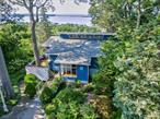 Perched high above the Long Island Sound, this stunning four-bedroom, two-and-a-half-bath contemporary home offers panoramic water views that will take your breath away. Situated on a half-acre just blocks from downtown Northport, the propertyâ€™s elevated position provides sweeping vistas of the Long Island Sound, creating an ever-changing backdrop of sea and sky replete with stunning sunsets. Inside, the open floor plan and soaring ceilings create an airy, inviting atmosphere, while walls of windows flood the living spaces with natural light. The spacious living room and dining room, as well as the expansive deck are perfect for entertaining or simply enjoying quiet evenings with the water as your view. Mostly remodeled just a few years ago, the home features gleaming hardwood floors, a marble bath downstairs, a walk-in closet, motorized shades, a steam shower, carrera marble, a stunningly remodeled en suite primary bath, and skylights that add even more brightness to the interior. The kitchen is equipped with modern appliances added during the renovation, offering both style and functionality.Located mere moments from Main St â€” with its charming harbor-front village known for shopping, dining, and vibrant cultural life â€” this home also enjoys proximity to local favorites like the vineyard and golf course. Central air keeps the interior comfortable year-round, while natural gas ensures efficient heating and cooking. Whether as a primary residence or a weekend retreat, this remarkable property blends modern comfort with timeless coastal beauty in one of Long Islandâ€™s most sought-after locations.