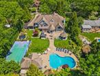 Welcome to a one-of-a-kind, custom built luxury residence in the prestigious Smithtown Pines, nestled within the desirable Hauppauge School District. Boasting 5, 735 sq ft of impeccably crafted living space, this custom home is a true masterpiece of design, comfort, and functionality.Step inside to discover a grand foyer with soaring ceilings, a massive great room with cathedral ceilings and a wood-burning fireplace, a formal dining room, a private home office, and a separate game room with a built-in barâ€”perfect for entertaining. The chefâ€™s kitchen is a culinary dream, outfitted with Wolf & Sub-Zero appliances, custom cabinetry and high-end finishes throughout.The finished basement offers an expansive private in-law suite, a movie theater and abundant storage with a separate entrance.Outdoors, enjoy a resort-style backyard which features a heated in-ground pool, a pool house with an outdoor bathroom, an outdoor kitchen with built-in BBQ, gazebo with a mounted TV, a multi-sport sports court and a fenced yard for privacy and safety. This outdoor oasis is perfect for vacationing at home or entertaining guests all year long.Back inside to retreat to the massive primary suite, featuring a spa-inspired bathroom and a 250 sq ft walk-in closet that dreams are made of. 10 Colonial Drive is not only an exceptional home, but it&rsquo;s a lifestyle. Live, work and play in high-end comfort.Additional Parcel Included (Tax ID: 0800-151-00-03-00-002-002)